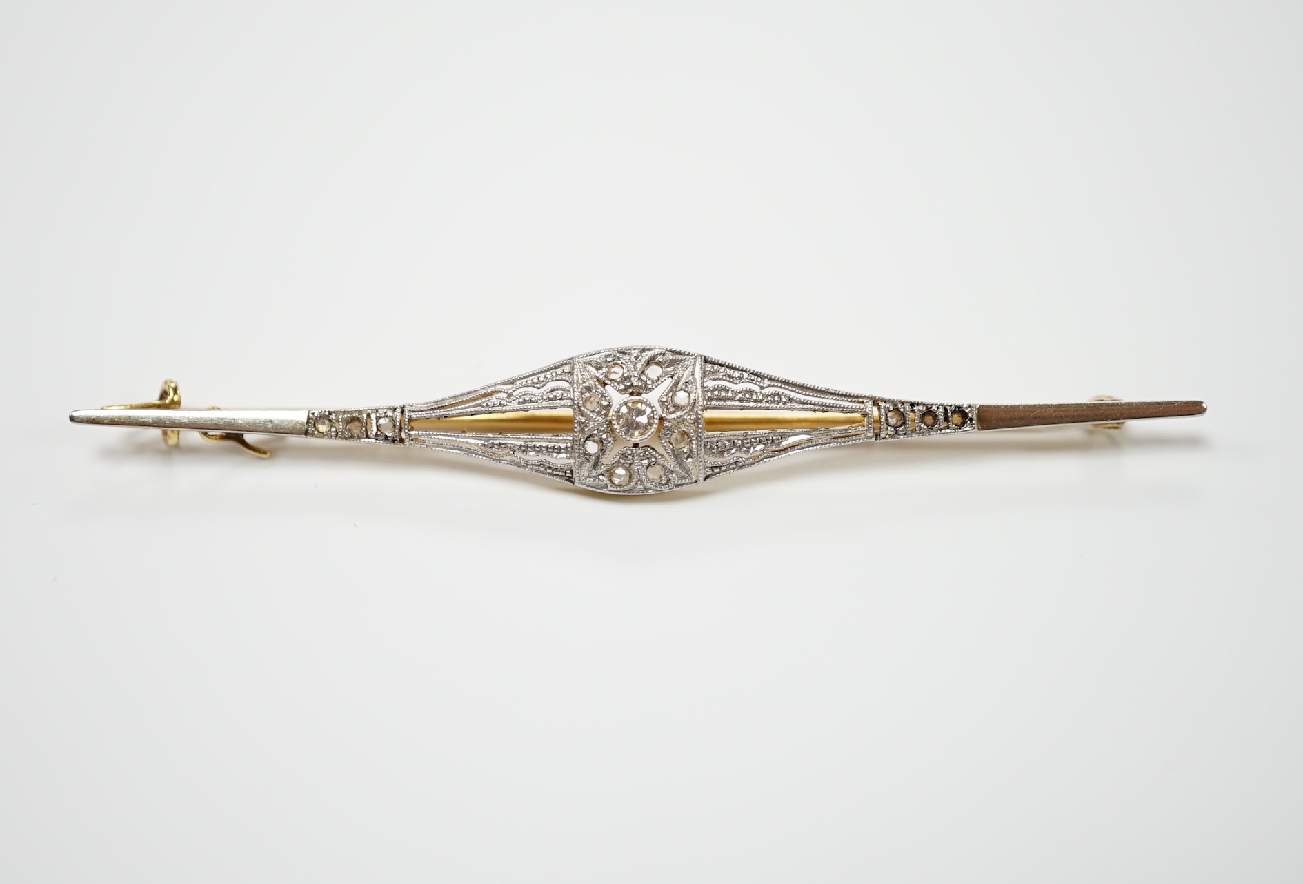 A Belle Époque yellow metal and diamond chip set bar brooch, 70mm, gross weight 3.7 grams.